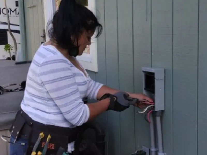 Licensed electrician wiring an exterior subpanel in Rapho